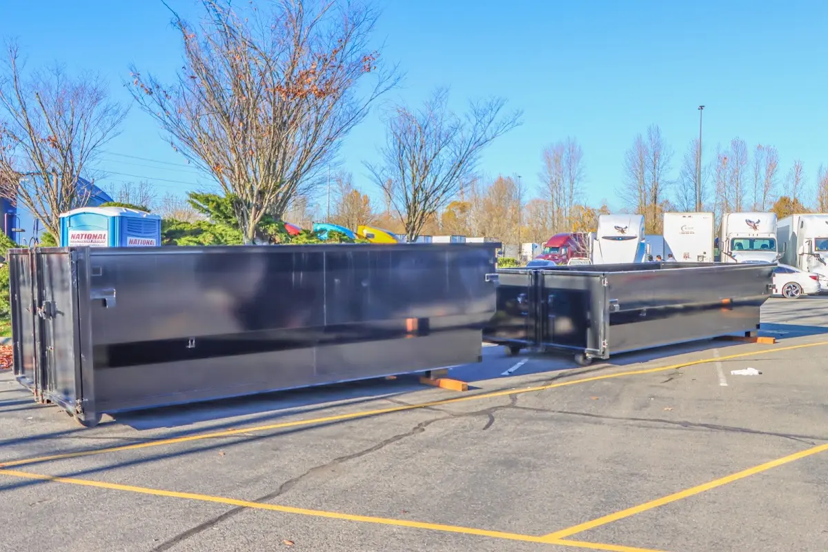 Professional dumpster rental service with roll-off container on residential driveway in Painesville